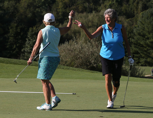 Photo of two golfers playing in a tournament in memory of two woman who fought for ovarian cancer awareness. 