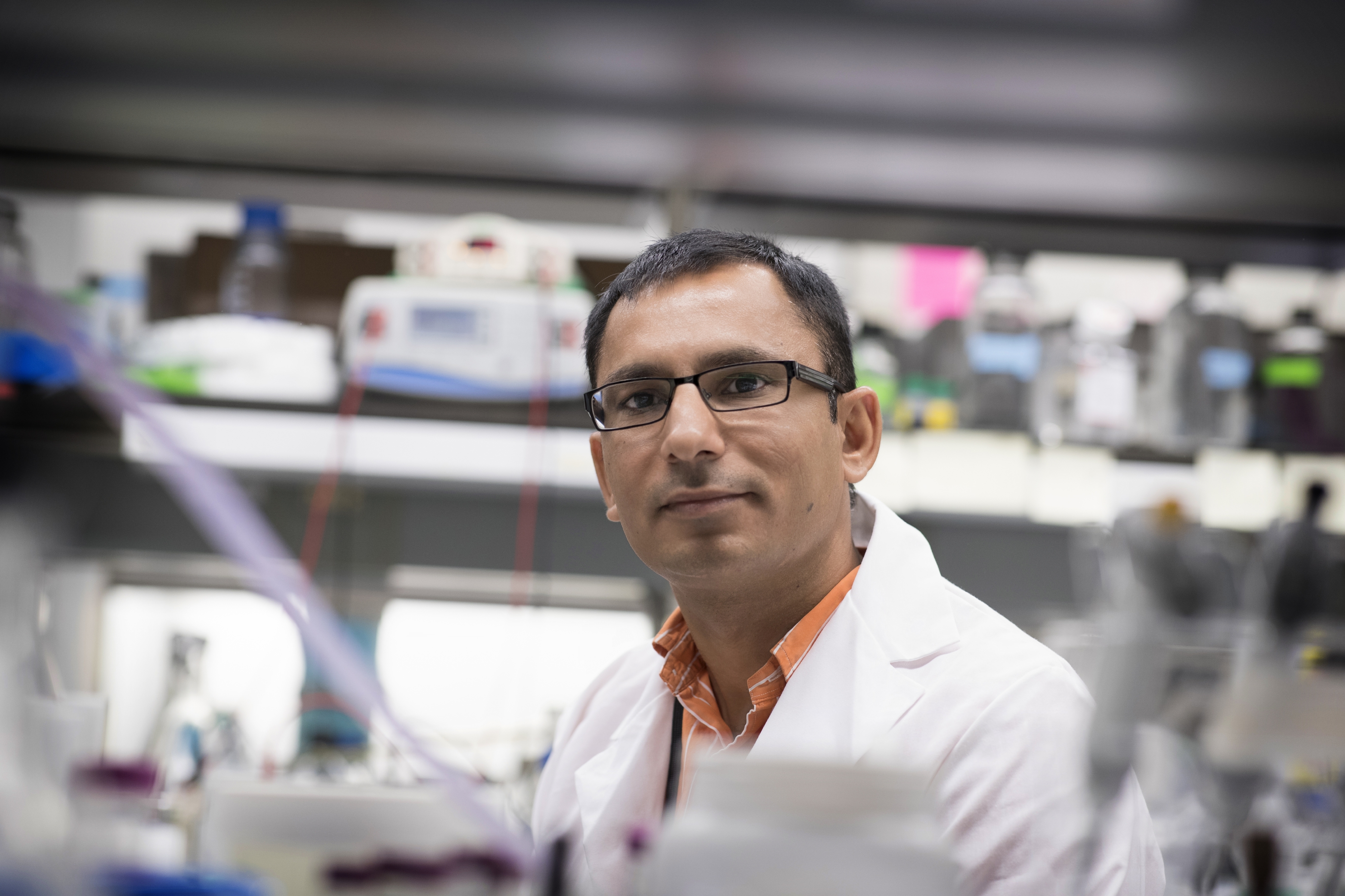 Jogender Tushir-Singh, PhD, stands in the lab