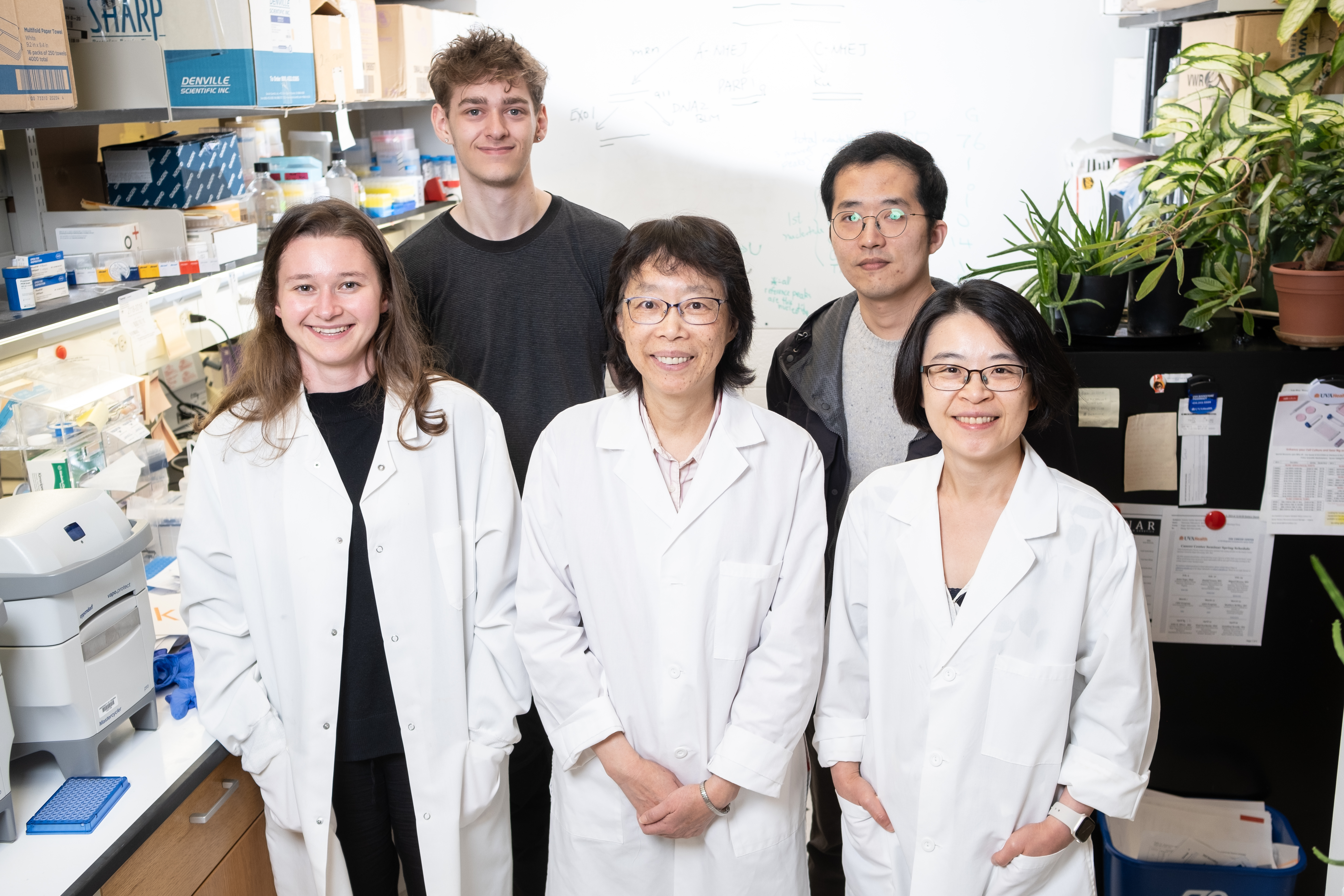 Dr. Wang's team stands in the lab 