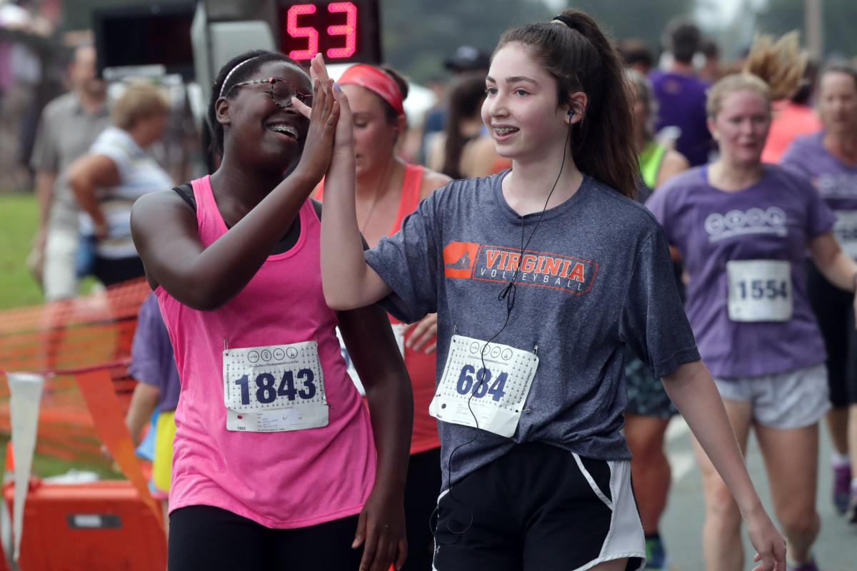 Runners high five at the Charlottesville Women's Four Miler.