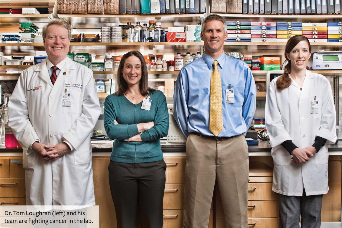 Dr. Tom Loughran and his team in the lab. 