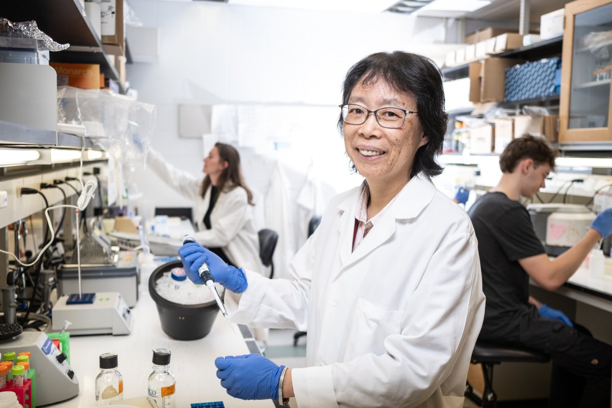 Dr. Wang smiles in her lab