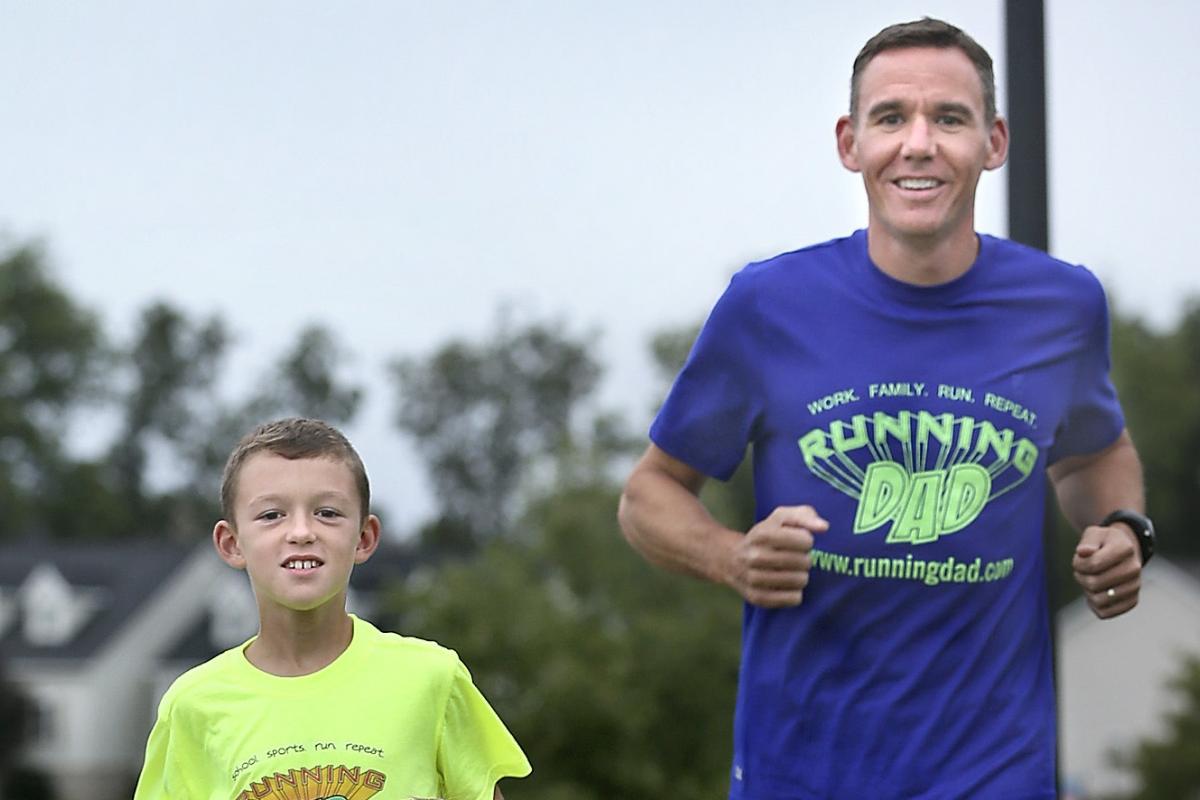 Jeremy Sanders, the running dad, runs with his son.
