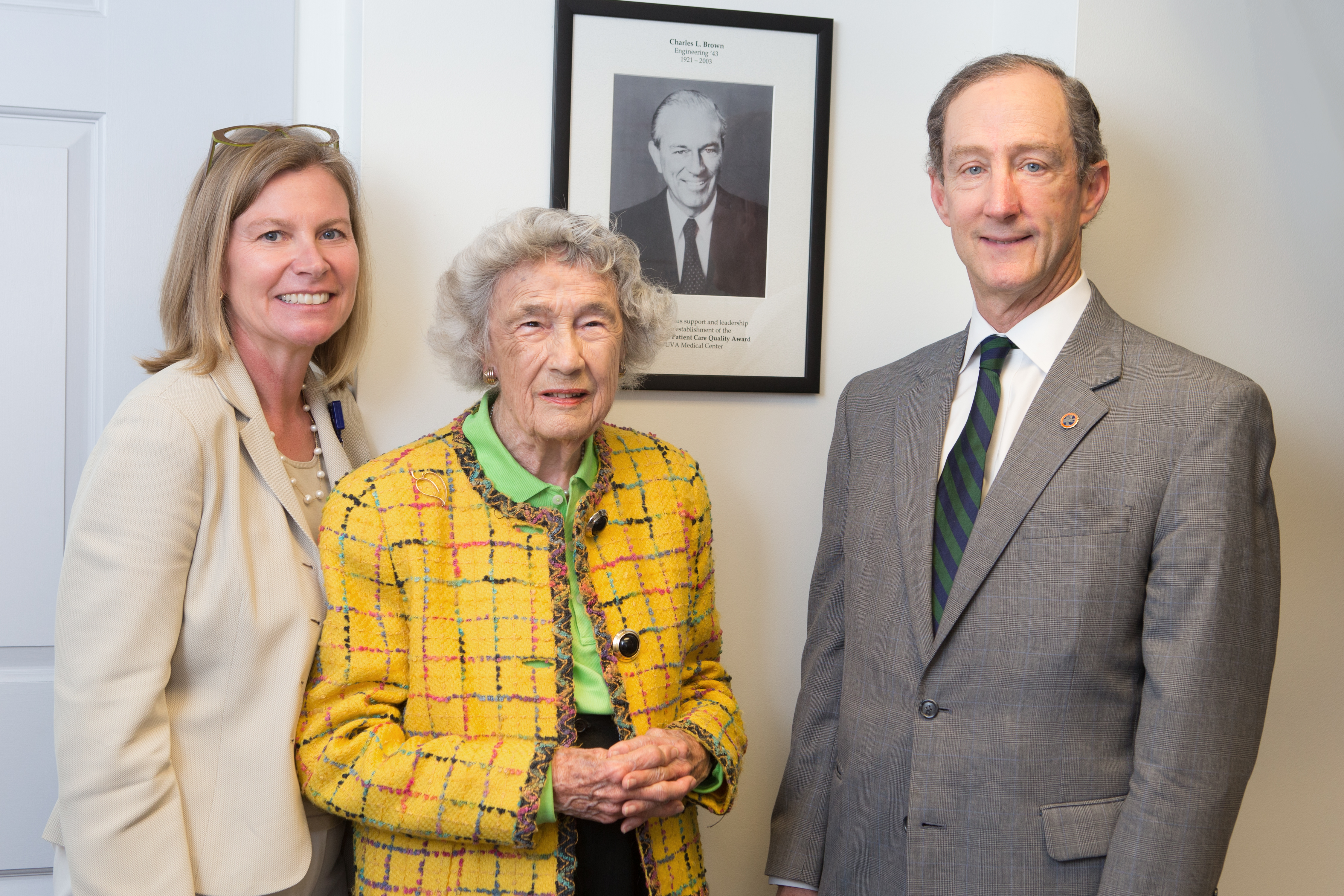 Ann Lee Saunders Brown (center) celebrates with Drs. Tracey Hoke and Rick Shannon at the unveiling of a portrait of her late husband, Charles Brown, 