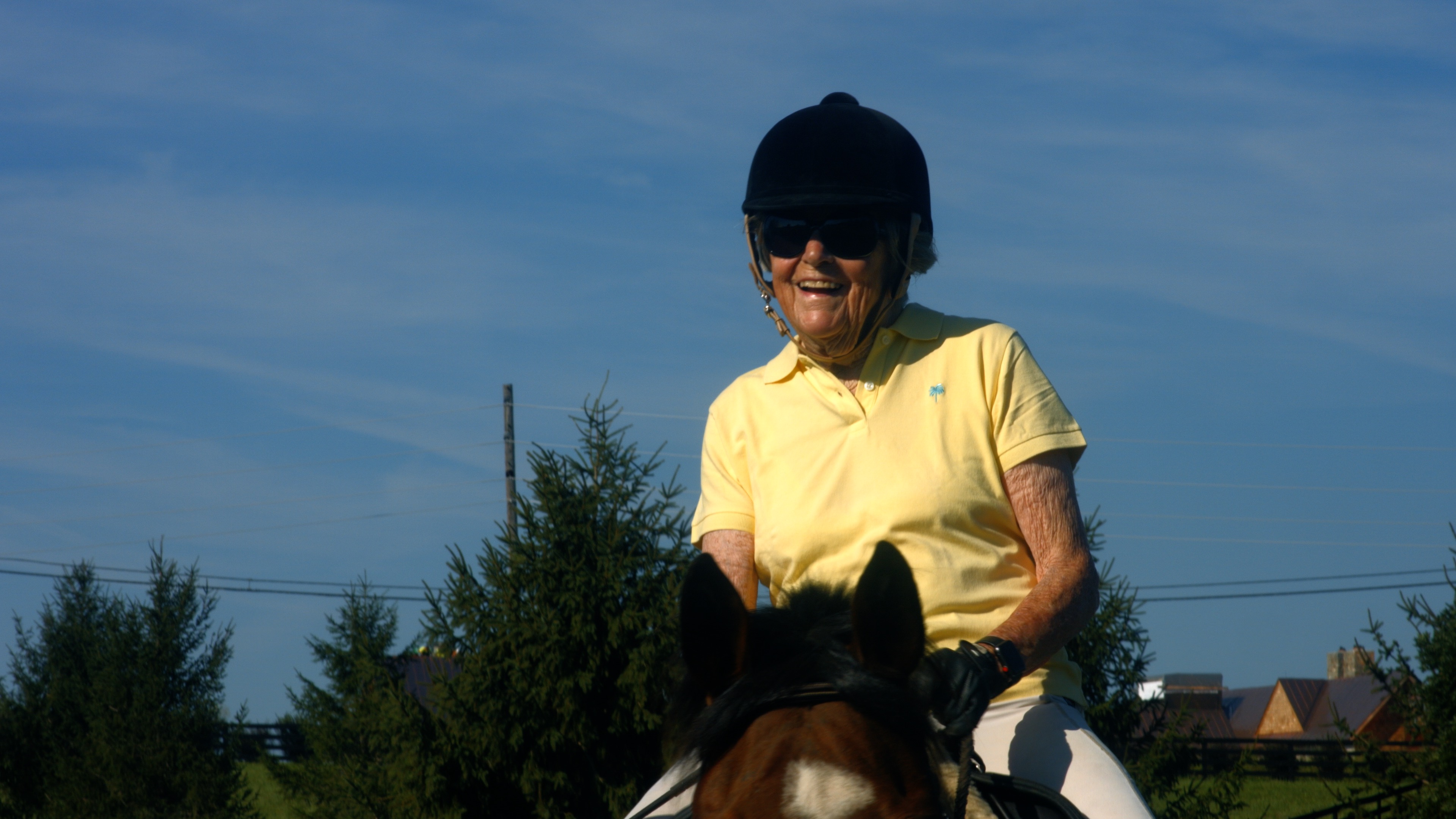 Dr. Carol Angle smiles as she rides her horse Tigger.