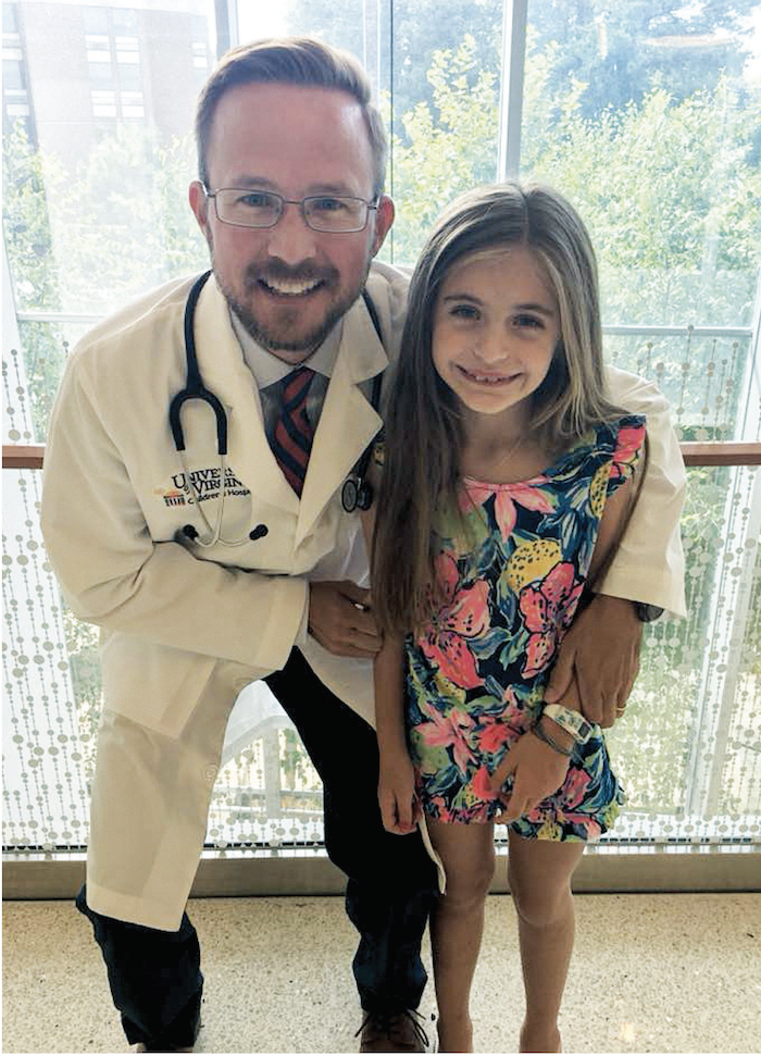 Cancer survivor Anna with Dr. Brian Belyea, the UVA pediatric oncologist who treated her.
