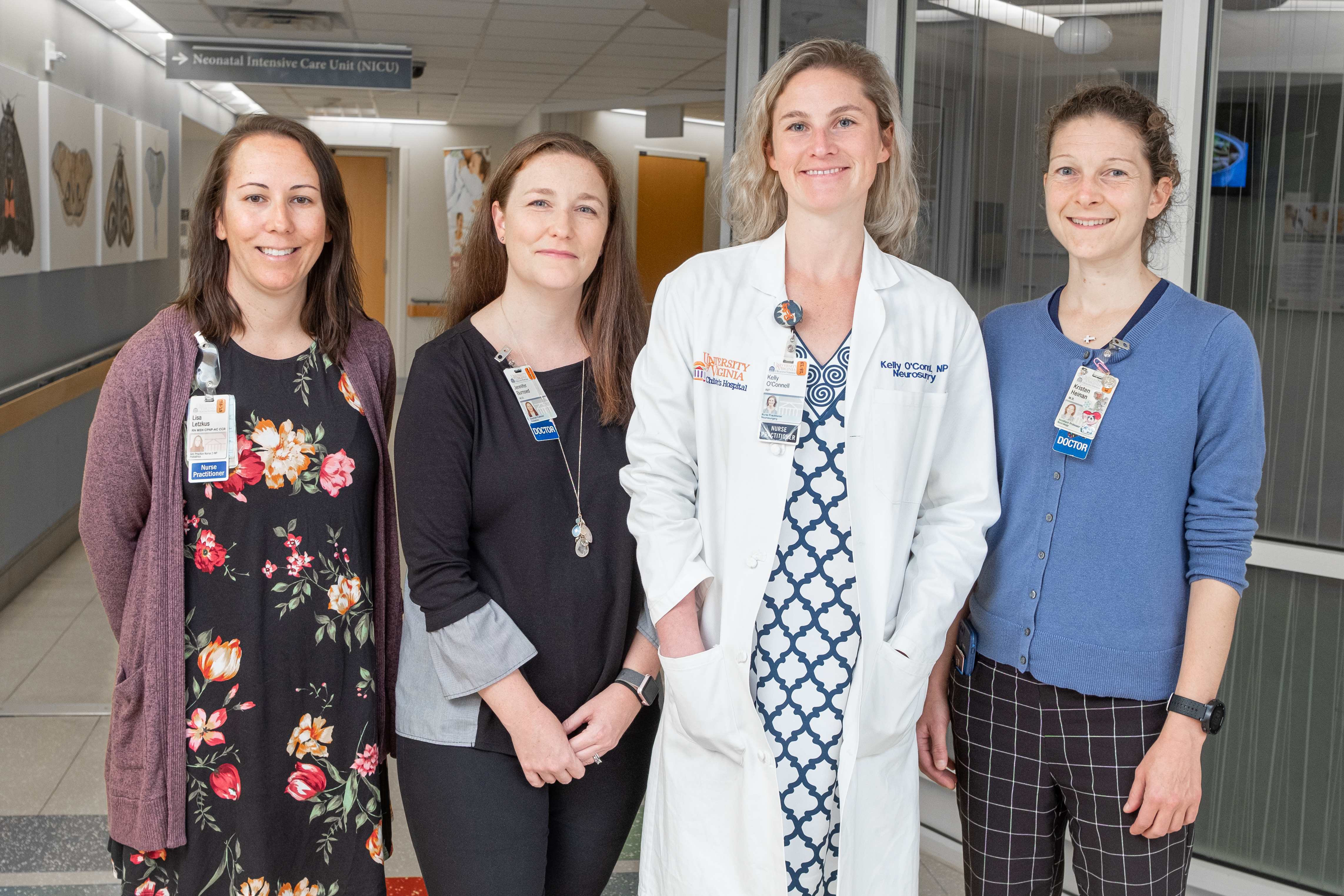 Members of the Neuro-NICU team, from left to right: Lisa Letzkus, Dr. Jennifer Burnsed, Kelly O’ Connell, and Dr. Kristen Heinan stand in front of the entrance to the NICU