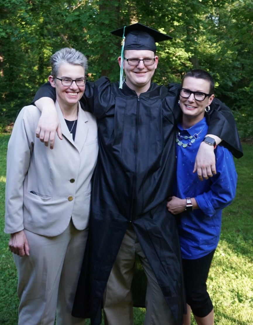 Kathy and Kim with their son Greyson at his high school graduation. 