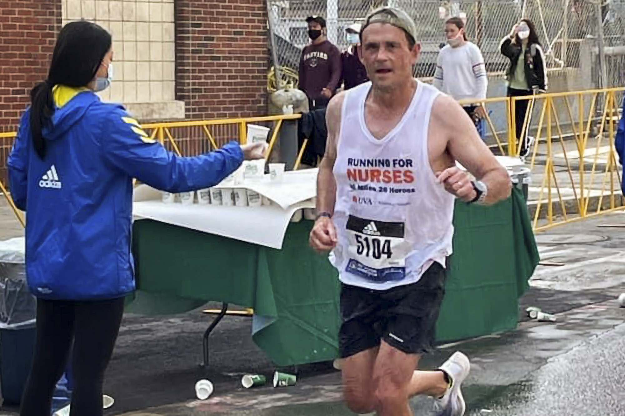 President Ryan mid-run wearing a white running for nurses shirt. 