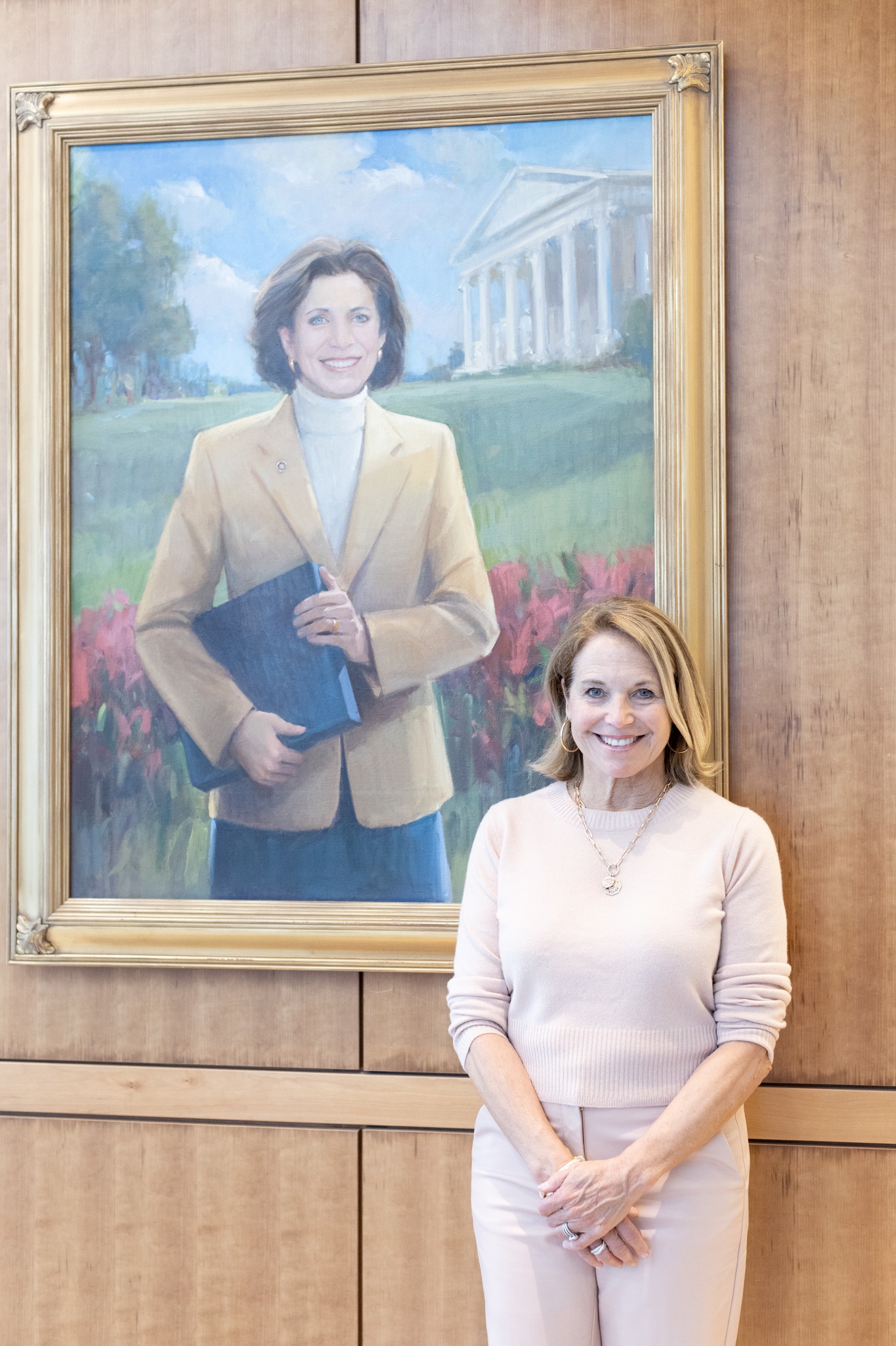 Couric stands in front of a portrait of her late sister