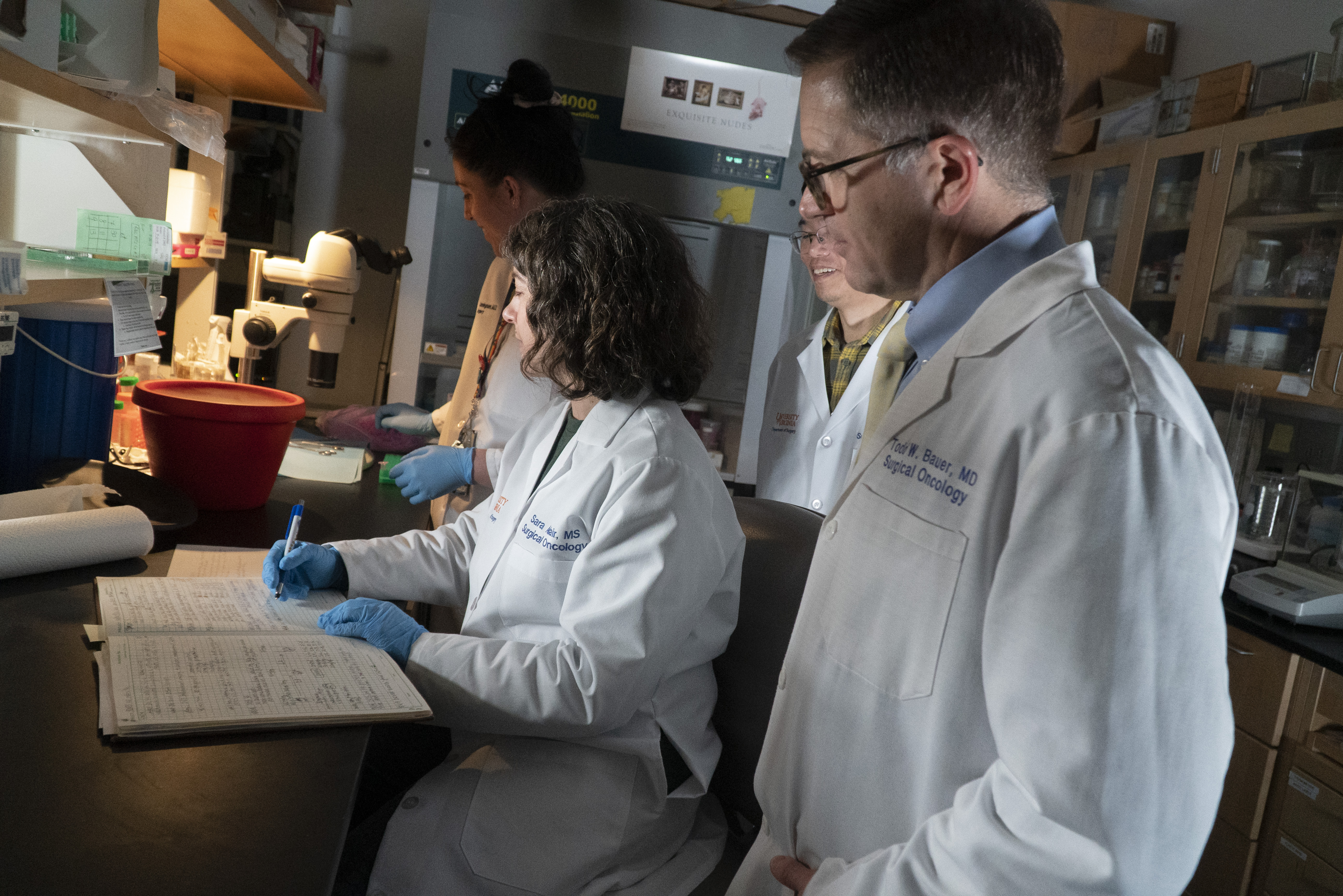 Dr. Bauer stands beside a researcher in his lab