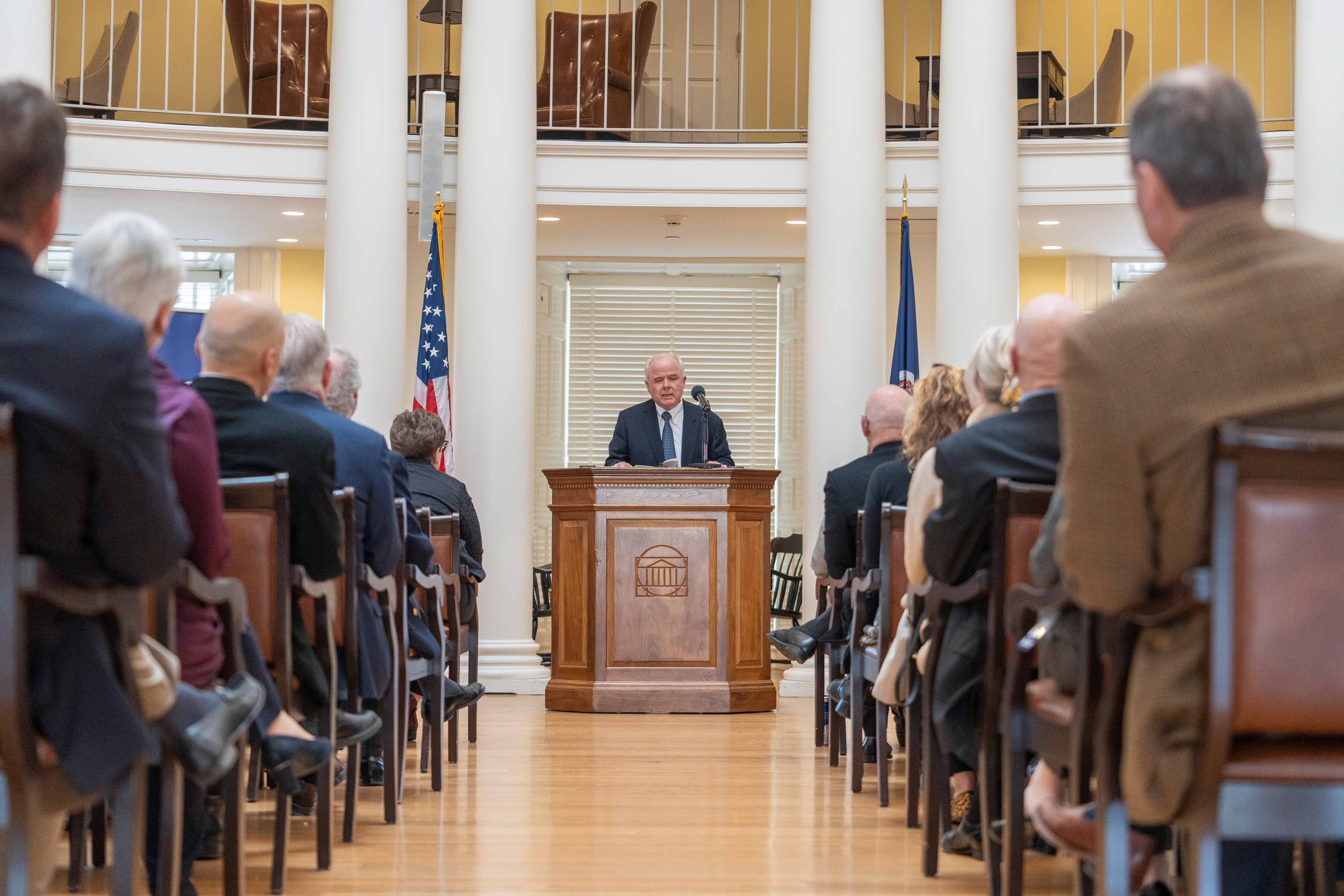 Paul Manning stands at a podium in the rotunda 