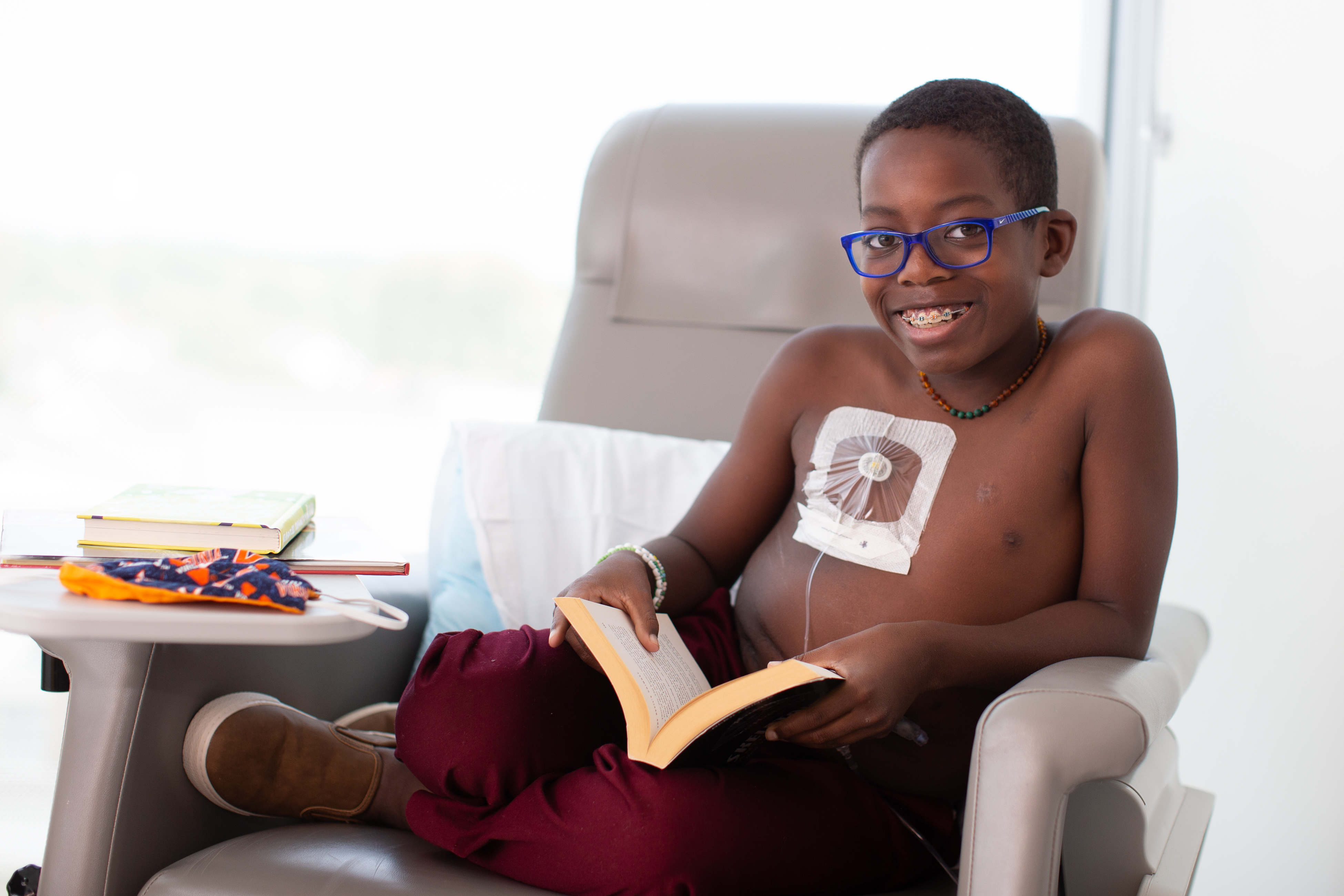 Kahmari sits in a chair during treatment 