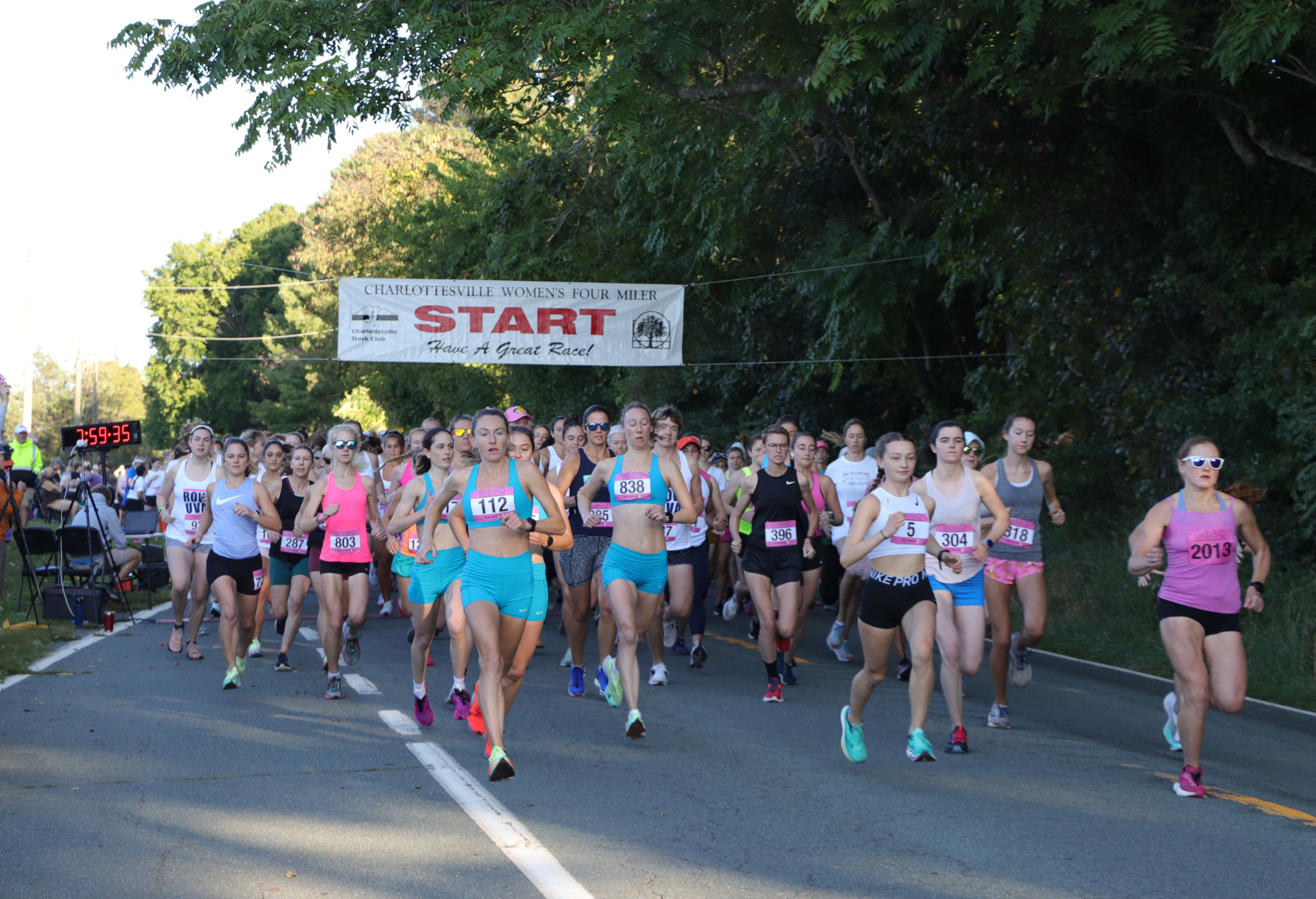 a group of women running as seen from the start line of the race