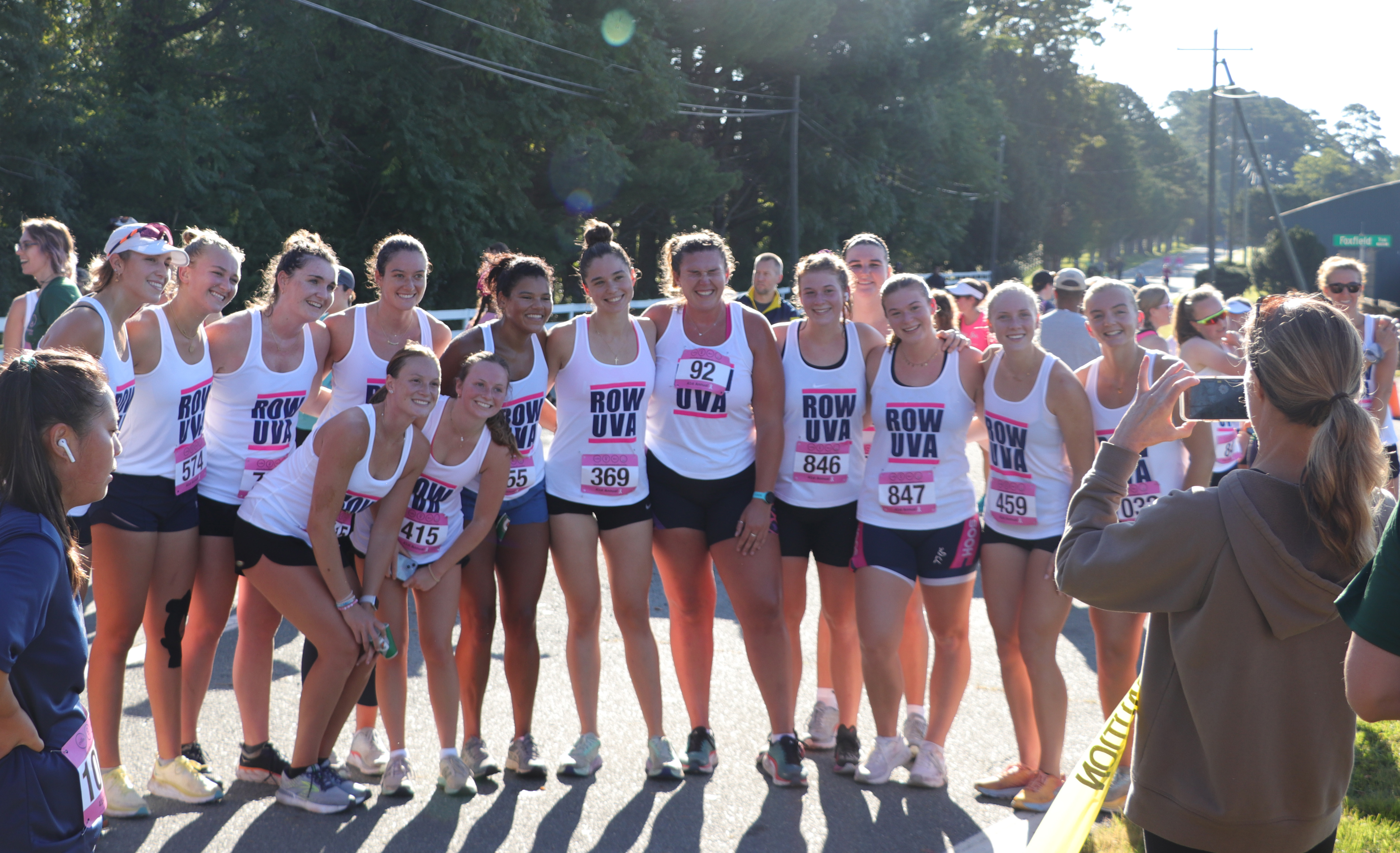 a group of girls on the UVA rowing team stand side by side for a photo