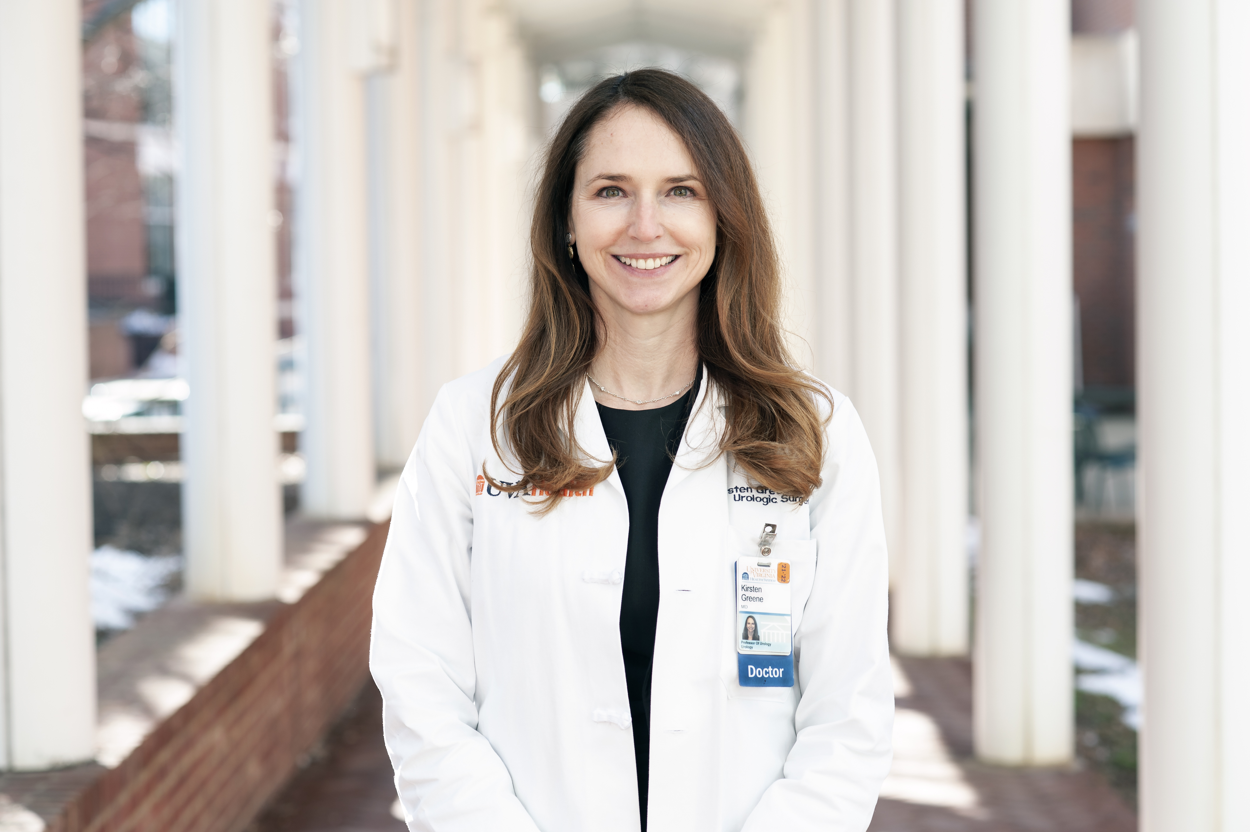 Kirsten Green stands in a white labcoat outside 