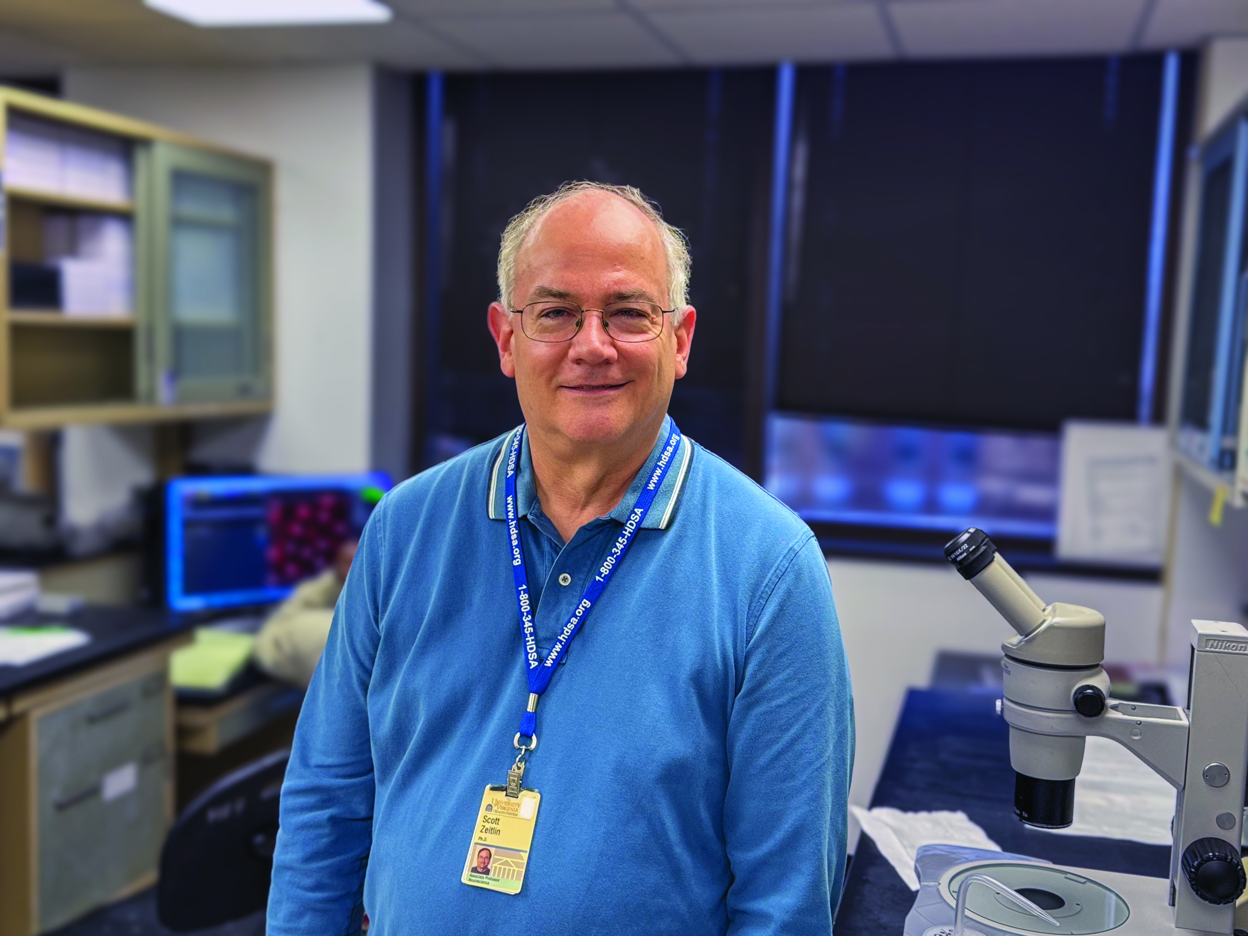 Scott Zeitlin stands in a lab looking at the camera