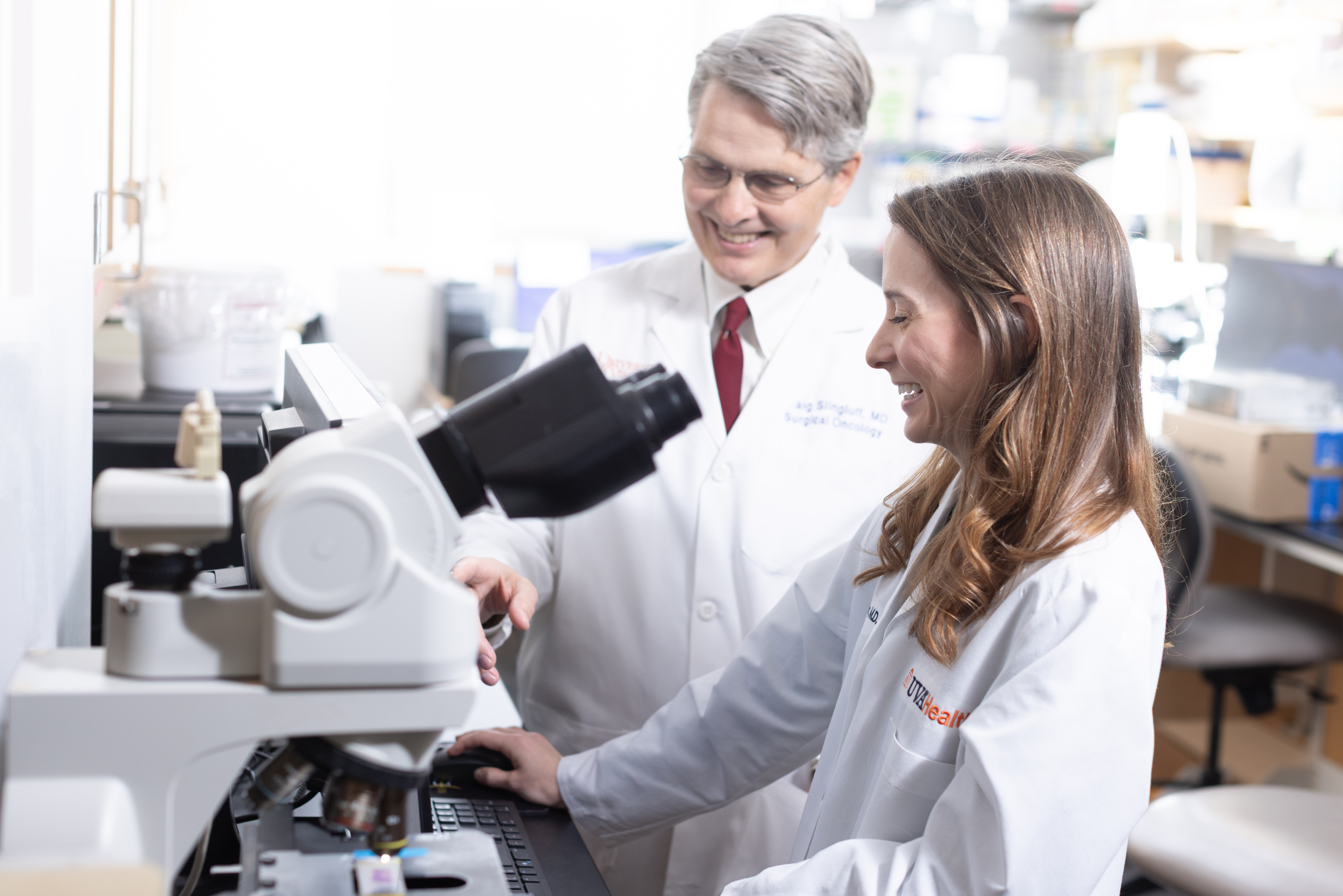 Dr. Ninmer and Dr. Slingluff with a microscope