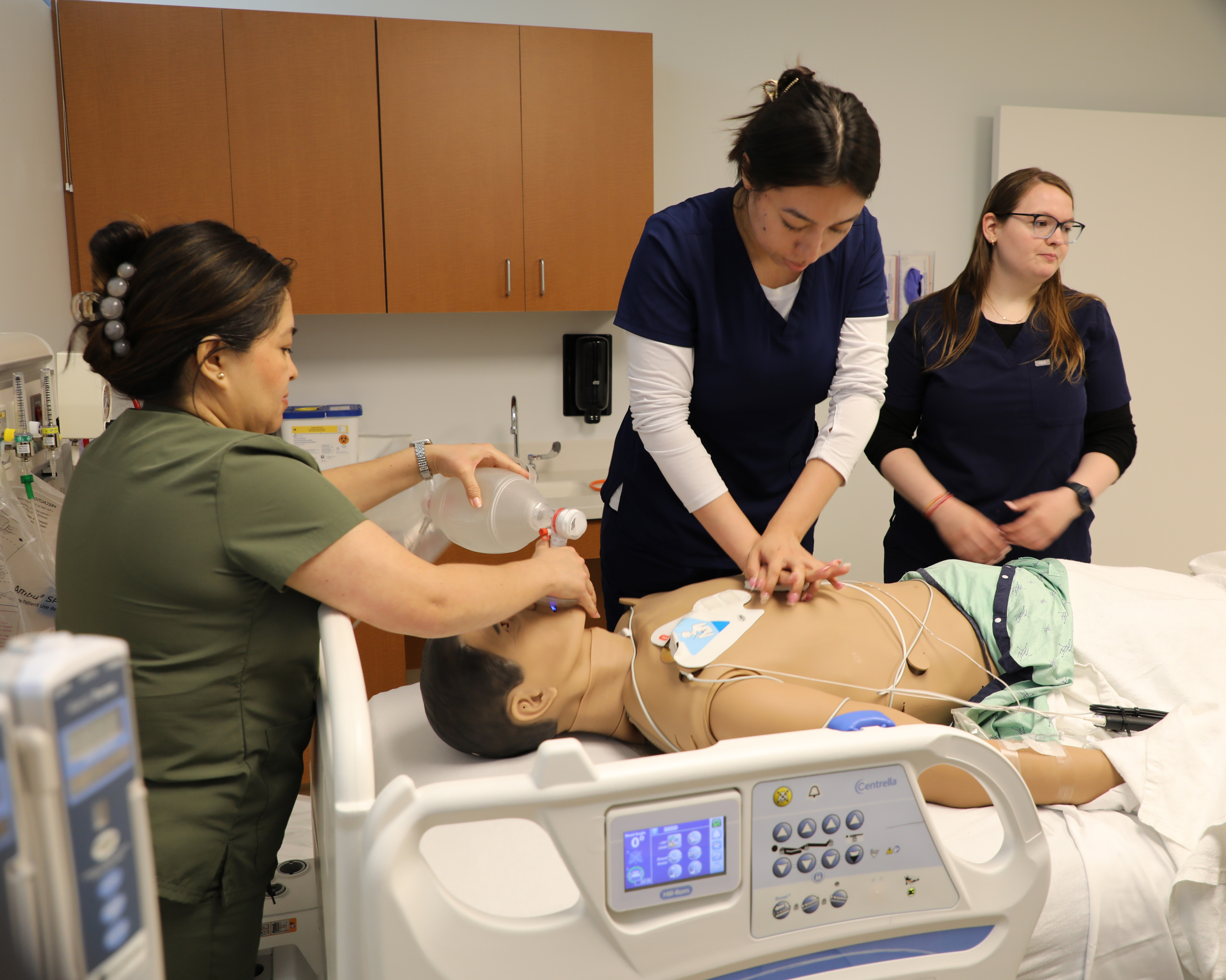 students work on a mannequin in the sim lab