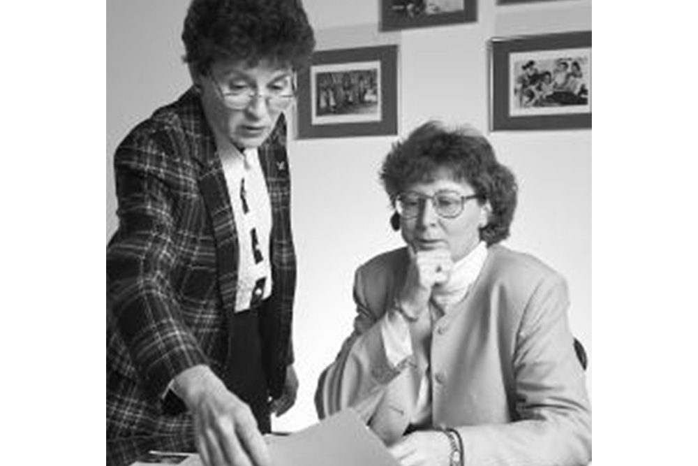 Arlene Keeling and Barbara Brodie look at a book