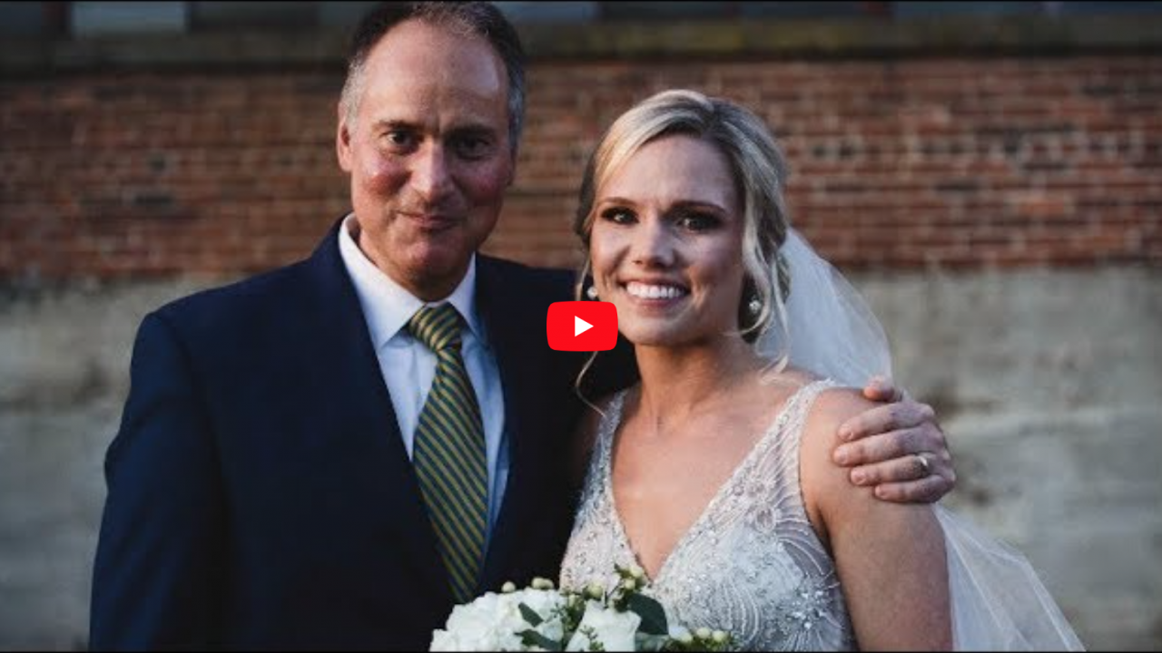 Addie Kingery stands with her surgeon, UVA's Dr. John Jane, at her wedding.