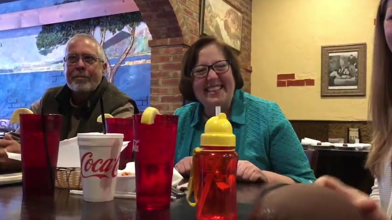 Nancy Whitley and her husband laugh over dinner.