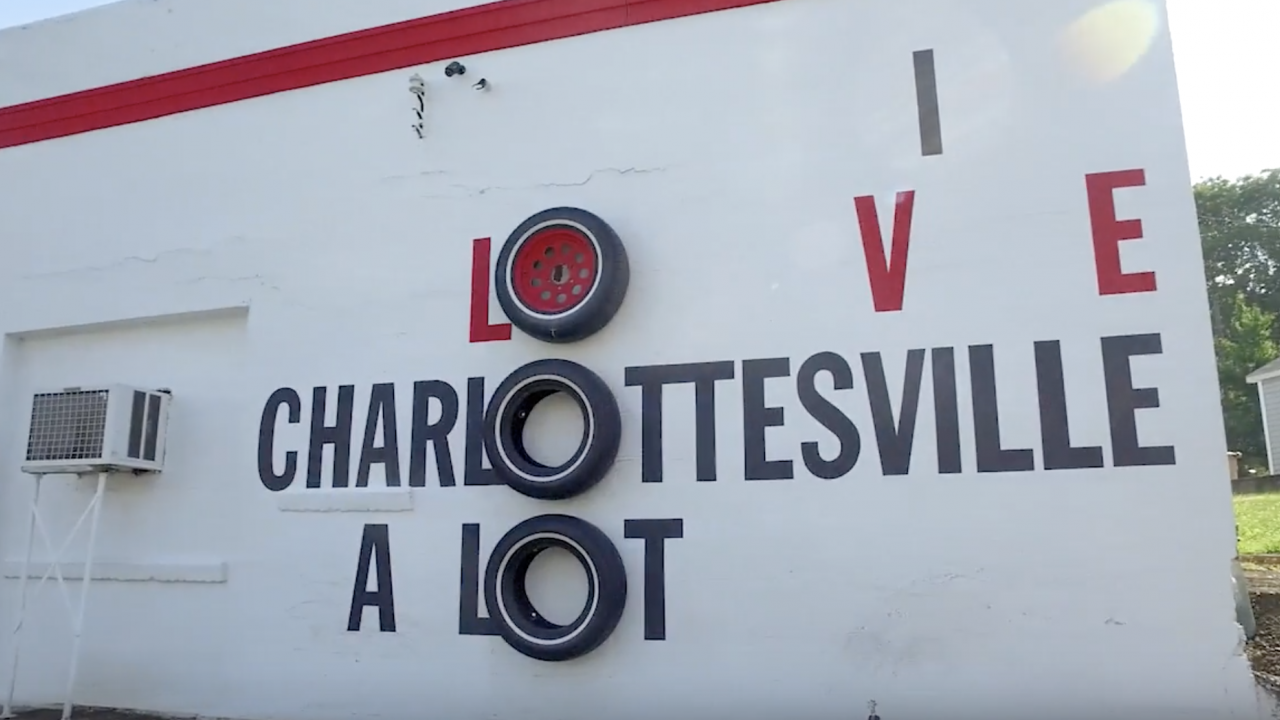 Garage wall that has "I love Charlottesville a lot" painted on it.