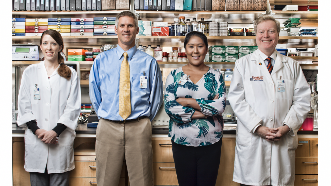 Dr. Loughran and reserachers stand in the lab. 