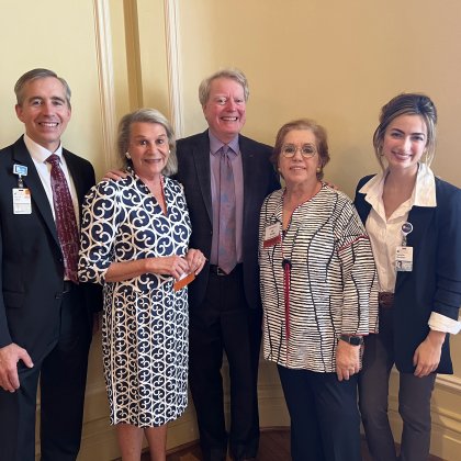 five members of the Cancer Center team stand together at the event