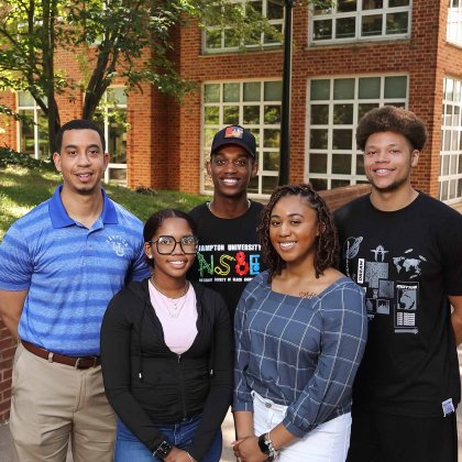 Jerald Dumas stands outside with a group of students 