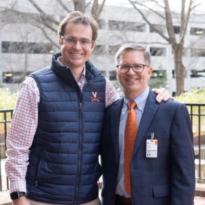 Peter Farrell stands with his arm around Todd Bauer, MD,