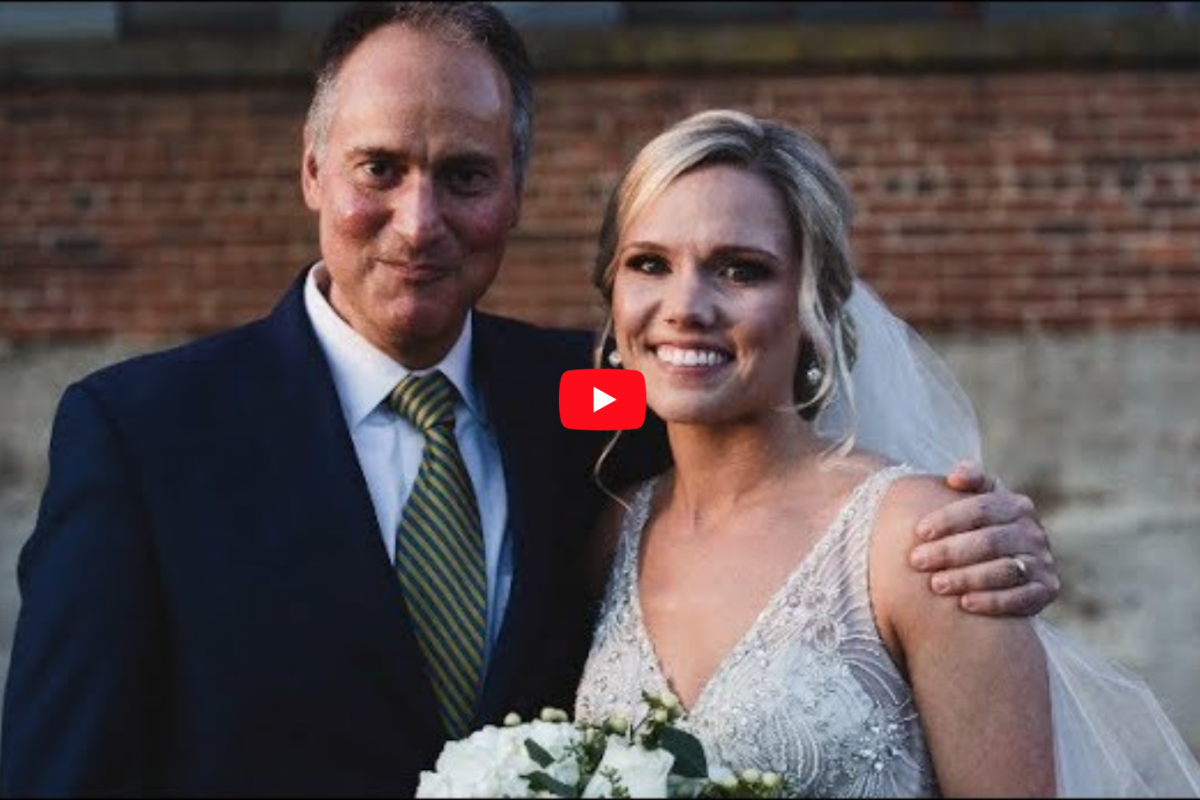 Addie Kingery stands with her surgeon, UVA's Dr. John Jane, at her wedding.