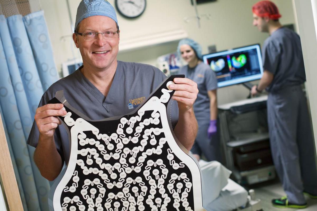 Dr. Mangrum holds up a special vest invention.