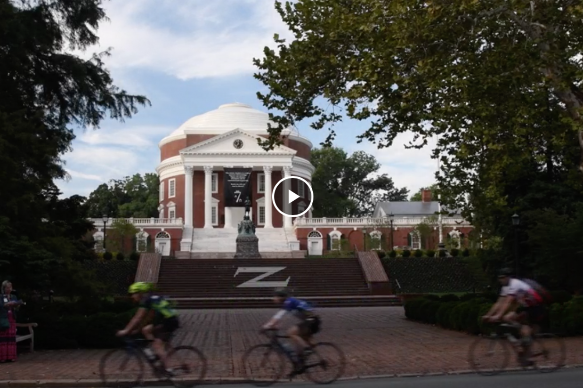 The rotunda is in the background, cyclists are seen riding by.