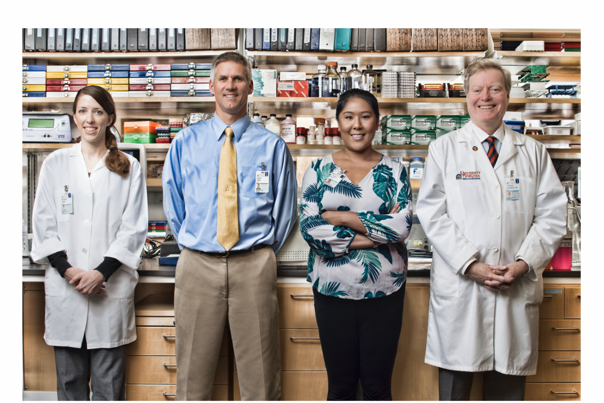 Dr. Loughran and reserachers stand in the lab.
