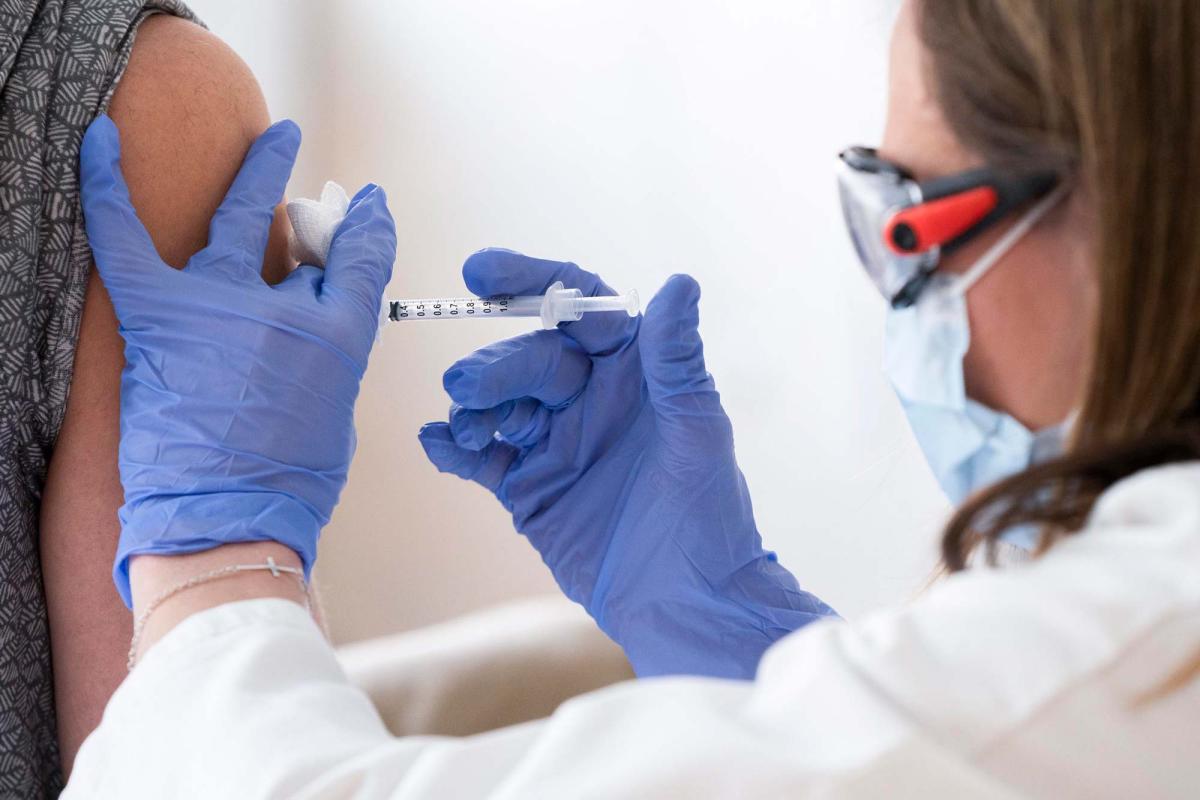 doctor gives vaccine to patient