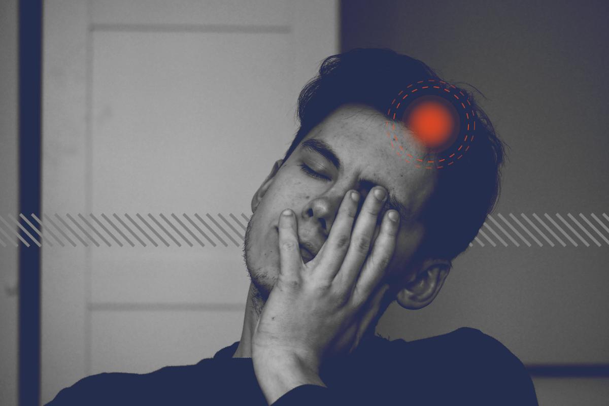 individual with head in hands while experiencing pain