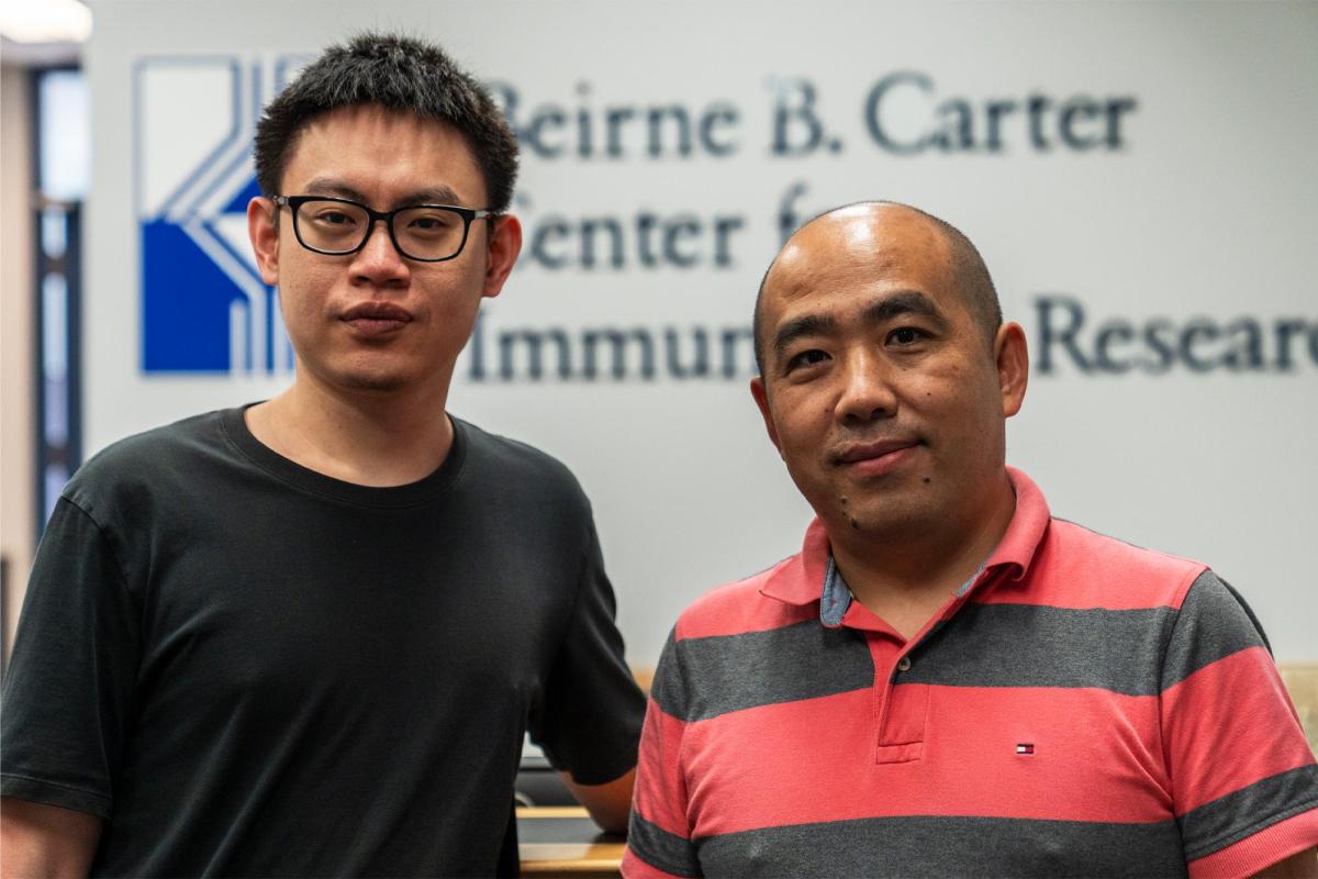 Jinyi Tang, research associate at UVA Health, stands with coordinator Jie Sun of the University’s Carter Immunology Center.