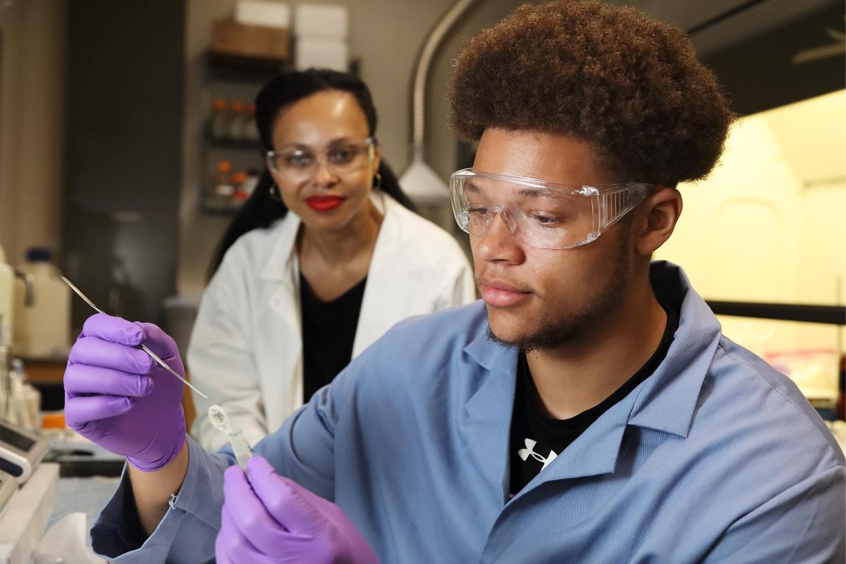 Caleb Tyson takes samples in a lab