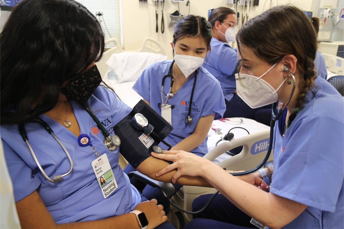 Students in the Nursing School’s new two-year accelerated BSN program practice checking one another’s blood pressure in the simulation lab.