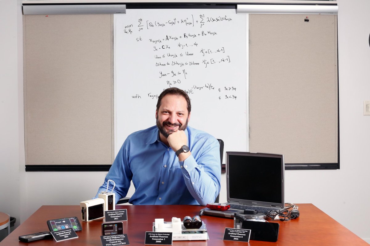 Marc Breton sits as his desk
