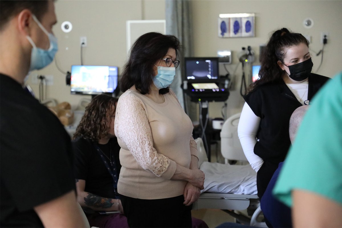 Sentara nurse Janice Lavoie stands and listens to an instructor 