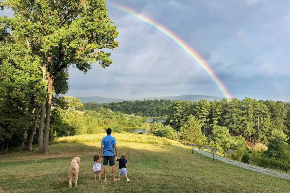 the Piper family stands and observes a rainbow