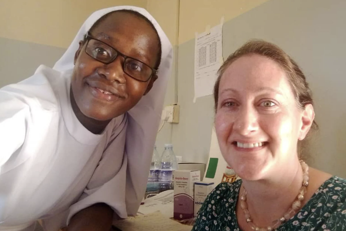 two women next to eachother smile at the camera