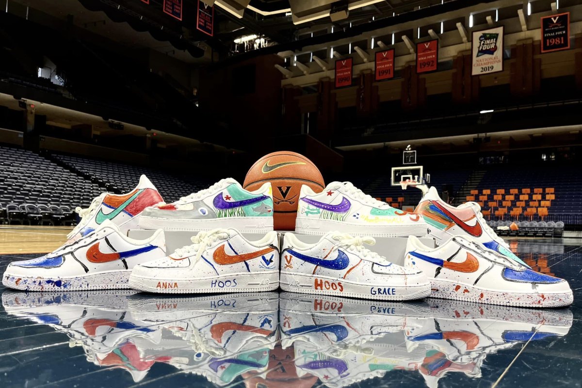 painted shoes on the court with a uva basketball