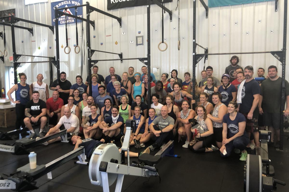 Rowers at CrossFit Nittany sit together after raising money for UVA. 