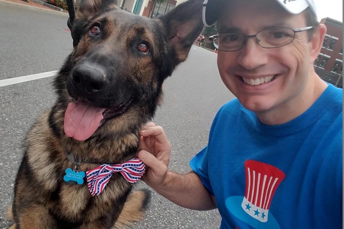 James Hiter poses with his German Shepherd dog during a run.