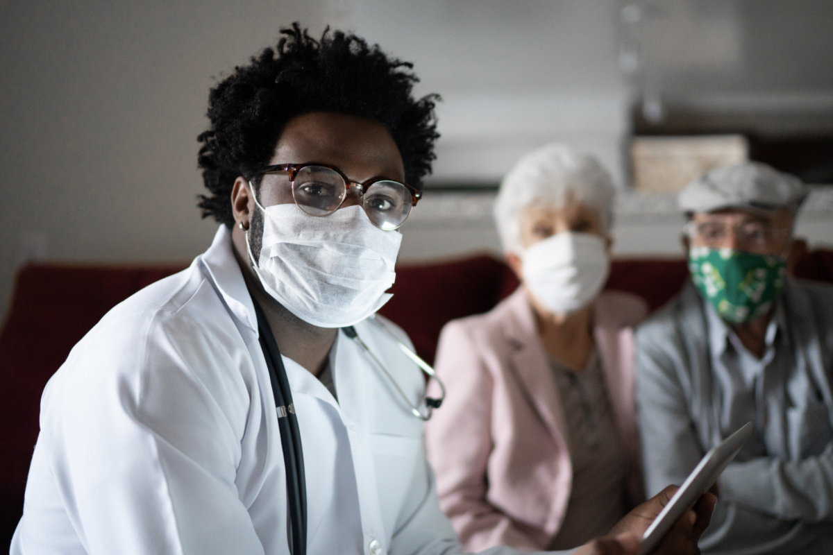 Doctor with two patients in background