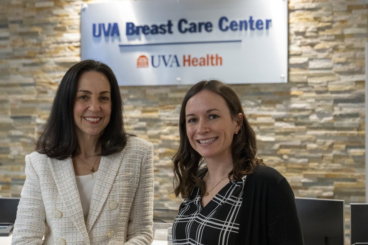 Drs Millard and Showalter stand in front of the uva breast care center sign