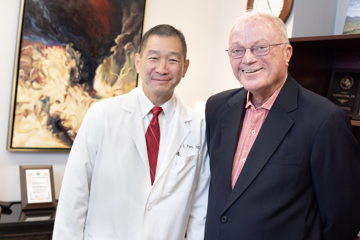 Dr. Park and John Reid stand side by side smiling 